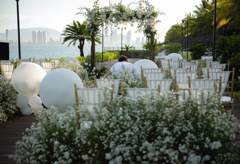 Gold chairs, white spheres and baby's breath set up by the crew on the sea deck at Amiana Resort Gold chairs, white spheres and baby's breath set up by the crew on the sea deck at Amiana Resort
