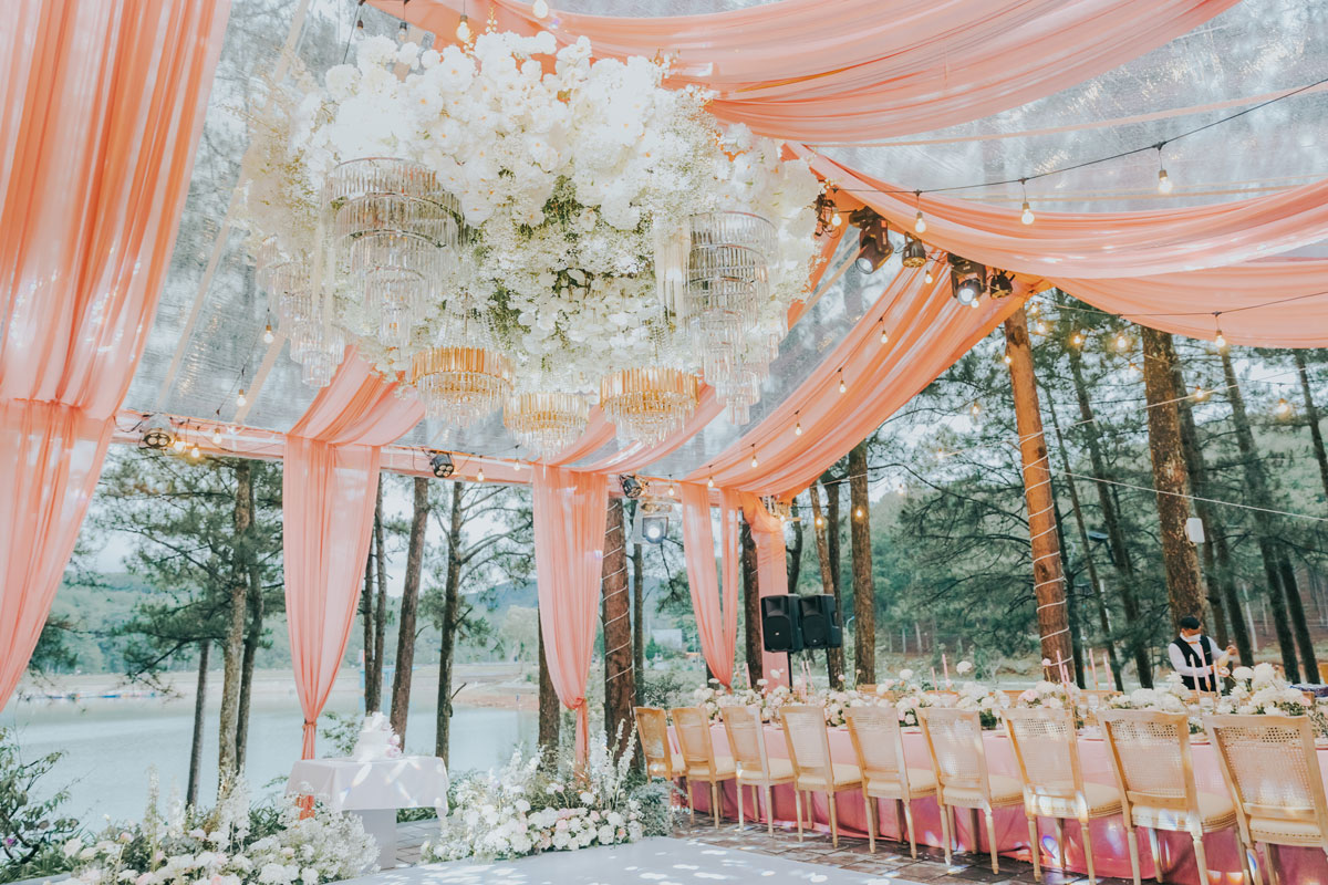 Nha Trang Wedding Resort Decor: Amiana and Alibu Ceremonies Long blush tables and rattan chairs in a clear marquee among pines by Tuyen Lam Lake