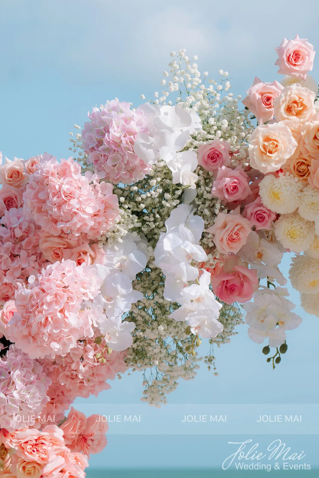 Close-up of the arch: pink hydrangea, peach and pink roses, white orchids and baby's breath against the sky Close-up of the arch: pink hydrangea, peach and pink roses, white orchids and baby's breath against the sky